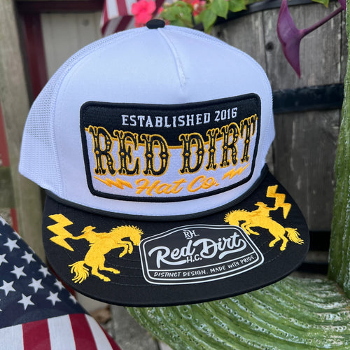 Red Dirt Hat Co white and black cap with gold bucking horse and lightning embroidery